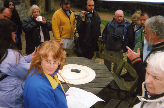 Robin Heath pointing at Avebury stone circle during tour